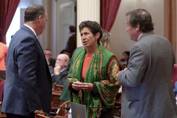 FILE - State Sen. Susan Talamantes Eggman, of Stockton, center talks with Republican state Senators Brian Dahle, of Bieber, left, and Scott Wilk, of Santa Clarita, at the Capitol in Sacramento, Calif., Sept. 12, 2023. Eggman introduced a bill to reform the state's conservatorship system. (AP Photo/Rich Pedroncelli, File)