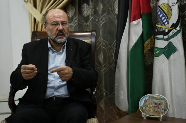 Ali Barakeh, a member of Hamas’ exiled leadership, speaks during an interview with The Associated Press in Beirut, Lebanon, Monday, Oct. 9, 2023. Barakeh on Monday denied that Iran or the Lebanese Hezbollah had helped plan or were even aware of the wide-ranging incursion his group launched into Israel, but said “our allies will join the battle if Gaza is subjected to a war of annihilation.” (AP Photo/Hussein Malla)