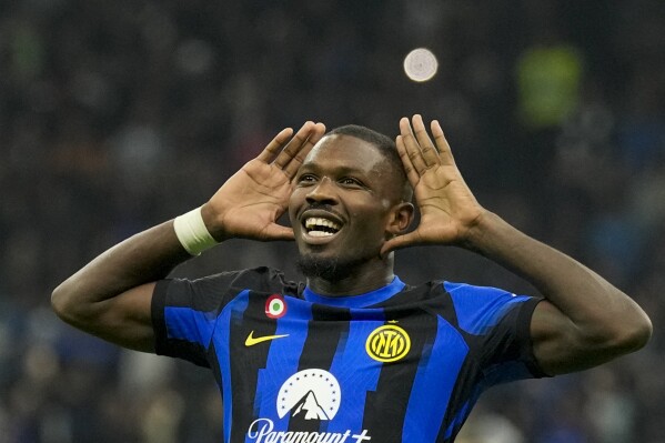 Inter Milan's Marcus Thuram celebrates after scoring his side's opening goal during the Serie A soccer match between Inter Milan and Roma at the San Siro Stadium, in Milan, Italy, Sunday, Oct. 29, 2023. (AP Photo/Antonio Calanni)