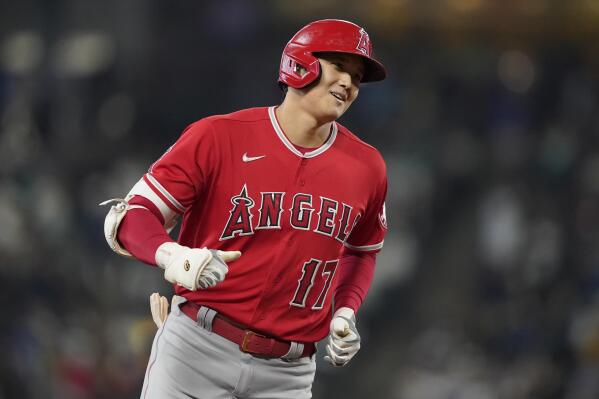 Los Angeles Angels' Shohei Ohtani rounds the bases after he hit a solo home run during the first inning of a baseball game against the Seattle Mariners, Sunday, Oct. 3, 2021, in Seattle. (AP Photo/Ted S. Warren)