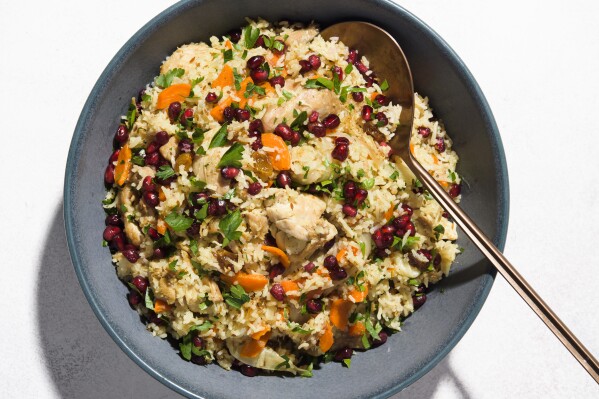 This image released by Milk Street shows a recipe for plov, a hearty pilaf, with chicken. (Milk Street via AP)