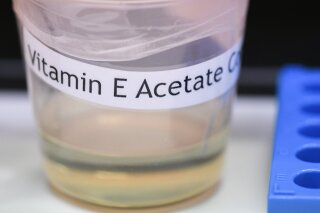 FILE - This Nov. 4, 2019 file photo shows a vitamin E acetate sample during a tour of the Medical Marijuana Laboratory of Organic and Analytical Chemistry at the Wadsworth Center in Albany, N.Y. Health officials say they have more evidence that a certain chemical compound is a culprit in a mysterious national outbreak of vaping illnesses. Earlier this month, the compound, vitamin E acetate, was found in the damaged lungs of 29 patients across the country who had vaped before growing ill. On Tuesday, Nov. 26, investigators in Minnesota said they looked at vaping cartridges gathered before and during the current outbreak. None of the cartridges collected last year had vitamin E acetate, but nearly all of the recent cartridges did.(AP Photo/Hans Pennink)