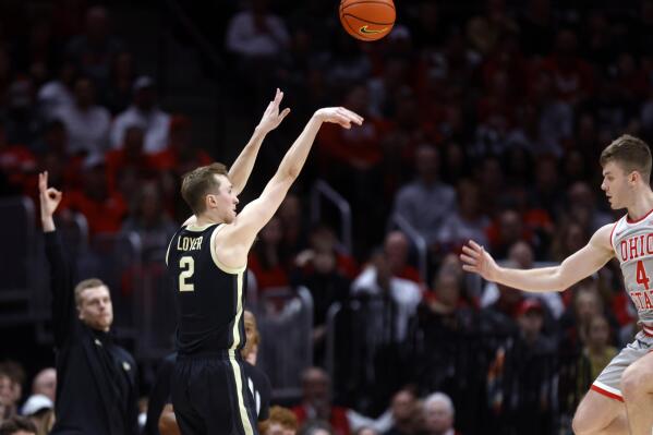 Purdue guard Fletcher Loyer, left, shoots in front of Ohio State guard Sean McNeil during the second half of an NCAA college basketball game in Columbus, Ohio, Thursday, Jan. 5, 2023. (AP Photo/Paul Vernon)