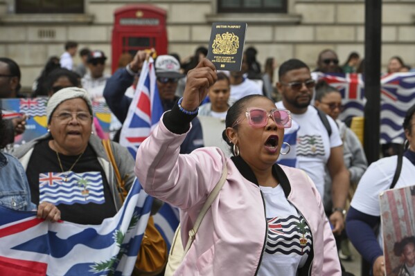 People demonstrate outside the Foreign Office in London, Thursday, May 22, 2025, after a British court blocked the U.K. from transferring sovereignty over the Chagos Islands to Mauritius hours before the agreement was due to be signed. (AP Photo/Thomas Krych)