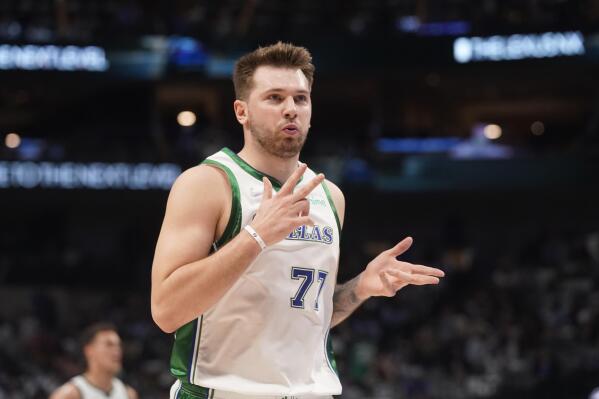 Dallas Mavericks guard Luka Doncic (77) blows on his fingers after scoring a three pointer during the first quarter of an NBA basketball game against the Los Angeles Lakers in Dallas, Tuesday, March 29, 2022. (AP Photo/LM Otero)