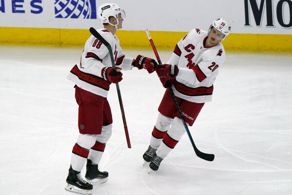 Carolina Hurricanes center Martin Necas, left, celebrates with center Sebastian Aho after scoring a goal against the Chicago Blackhawks during the third period of an NHL hockey game in Chicago, Wednesday, Nov. 3, 2021. (AP Photo/Nam Y. Huh)