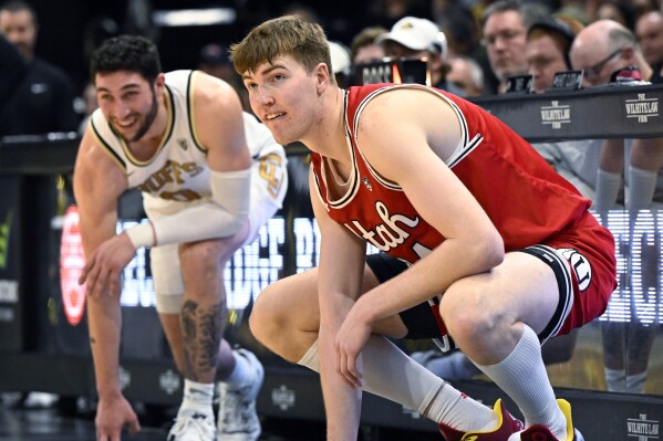 Utah forward Lawson Lovering, right, who used to play for Colorado, waits to check in as he makes his first appearance back in Boulder, Colo., in the first half of an NCAA college basketball game against Colorado, Saturday, Feb. 24, 2024. (AP Photo/Cliff Grassmick)