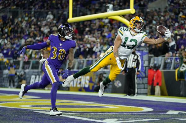 Green Bay Packers wide receiver Allen Lazard (13) reaches but is unable to hold on to a pass attempt in the end zone in front of Baltimore Ravens defensive back Kevon Seymour in the second half of an NFL football game, Sunday, Dec. 19, 2021, in Baltimore. (AP Photo/Julio Cortez)