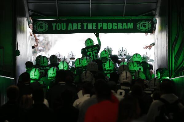 FILE - Michigan State players run through the tunnel to take the field before an NCAA college football game against Indiana, Saturday, Sept. 28, 2019, in East Lansing, Mich. Separate tunnels lead to and from the locker rooms in most stadiums built within the last 40 years, eliminating the possibility of an ugly scene unfolding like the one minutes after Saturday night's Michigan State-Michigan game. (AP Photo/Al Goldis)