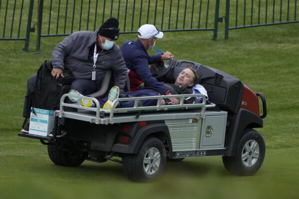Actor Tom Felton is helped after collapsing on the 18th hole during a practice day at the Ryder Cup at the Whistling Straits Golf Course Thursday, Sept. 23, 2021, in Sheboygan, Wis. (AP Photo/Ashley Landis)