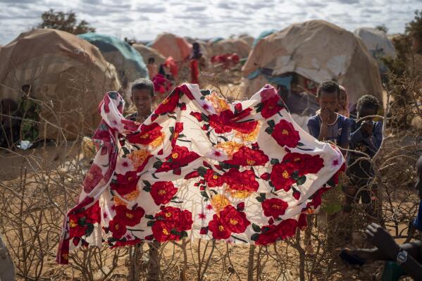 FILE - Children stand near shelters at a camp for displaced people on the outskirts of Dollow, Somalia, Sept. 19, 2022. (AP Photo/Jerome Delay, File)