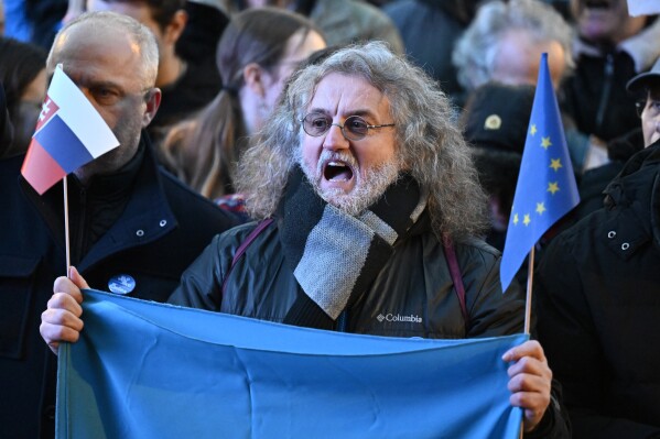 A protester shouts as thousands gather to oppose the policies of Slovakia's Prime Minister Robert Fico in Bratislava, Slovakia, Friday, Jan. 24, 2025. (AP Photo/Denes Erdos)
