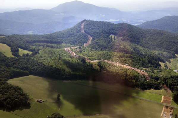 FILE - Cahas Mountain looms over the path of the Mountian Valley Pipeline as it crosses the Blue Ridge Parkway at Adney Gap on July 18, 2018. The Supreme Court is allowing construction to resume on a contested natural-gas pipeline that is being built through Virginia and West Virginia. Work had been halted by the federal appeals court in Richmond, even after Congress ordered the project's approval as part of the bipartisan bill to increase the debt ceiling. President Joe Biden signed the bill into law in June. (Heather Rousseau/The Roanoke Times via AP)