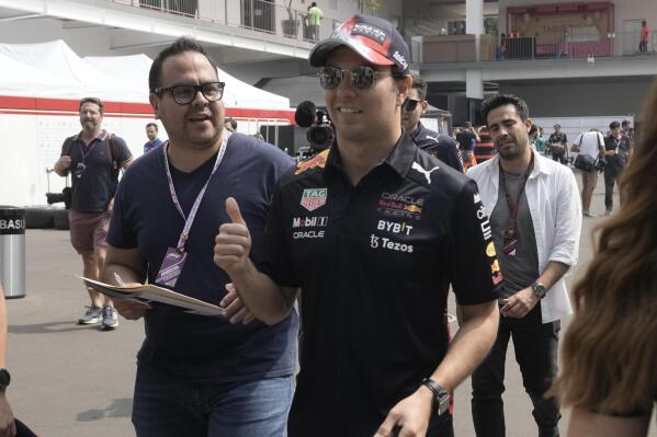 Red Bull driver Sergio Perez, of Mexico, flashes a thumbs up upon his arrival for the first day of the Formula One Mexico Grand Prix at the Hermanos Rodriguez racetrack in Mexico City, Thursday, Oct. 27, 2022. (AP Photo/Moises Castillo)