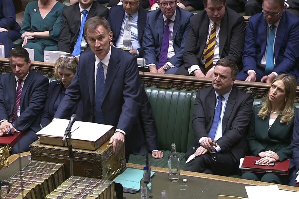 In this grab taken from video provided by the House of Commons, Britain's Chancellor of the Exchequer Jeremy Hunt delivers his autumn statement in the House of Commons, in London, Wednesday, Nov. 22, 2023. (House of Commons/UK Parliament, PA via AP)