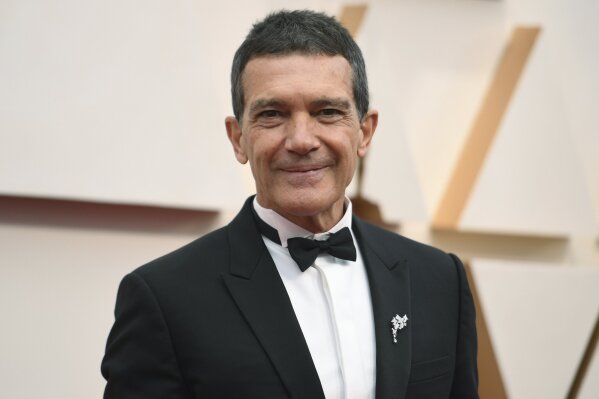 FILE - Antonio Banderas arrives at the Oscars in Los Angeles on Feb. 9, 2020.  Banderas says he’s tested positive for COVID-19 and is celebrating his 60th birthday in quarantine. The Spanish actor announced his positive test on Instagram on Monday. (Photo by Richard Shotwell/Invision/AP, File)