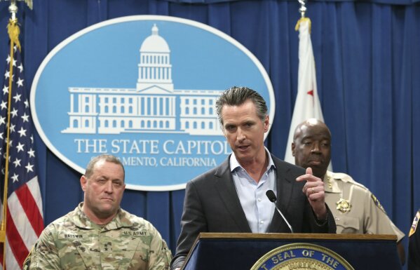 
              California Gov. Gavin Newsom, center, discusses his decision to withdraw several hundred National Guard troops from the nation's southern border and changing their mission, during a Capitol news conference Monday, Feb. 11, 2019, in Sacramento, Calif. Newsom, flanked by Major General David Baldwin, the Adjutant General of the California Military Department, left, and California Highway Patrol Commissioner Warren Stanley, right, said he will order the troops to leave by the end of March but will leave 100 troops to focus on drug trafficking. (AP Photo/Rich Pedroncelli)
            