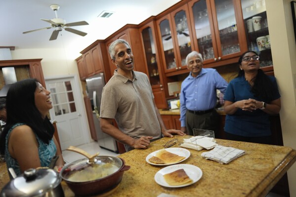 Politics tamfitronics Surgeon General Dr. Vivek Murthy, center, talks with family members including his wife Alice Chen, left, father Hallegere Murthy, second right, and sister Rashmi Murthy, during a visit to his parents' home, Tuesday, July 16, 2024, near Miami, Fla. (AP Photo/Rebecca Blackwell)