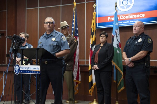 Washington County Sheriff Brian Albert speaks to the media in Hagerstown, Md., about the killing of Maryland circuit court Judge Andrew Wilkinson, Friday, Oct. 20. 2023. Listening from left are Washington County Sheriff Department public information officer Sgt. Carly Hose, Maryland State Police Lt. Col. Dan Pickett, Washington County State's Attorney Gina Cirincion and Hagerstown Police Chief Paul Kifer. (AP Photo/Jon Elswick)