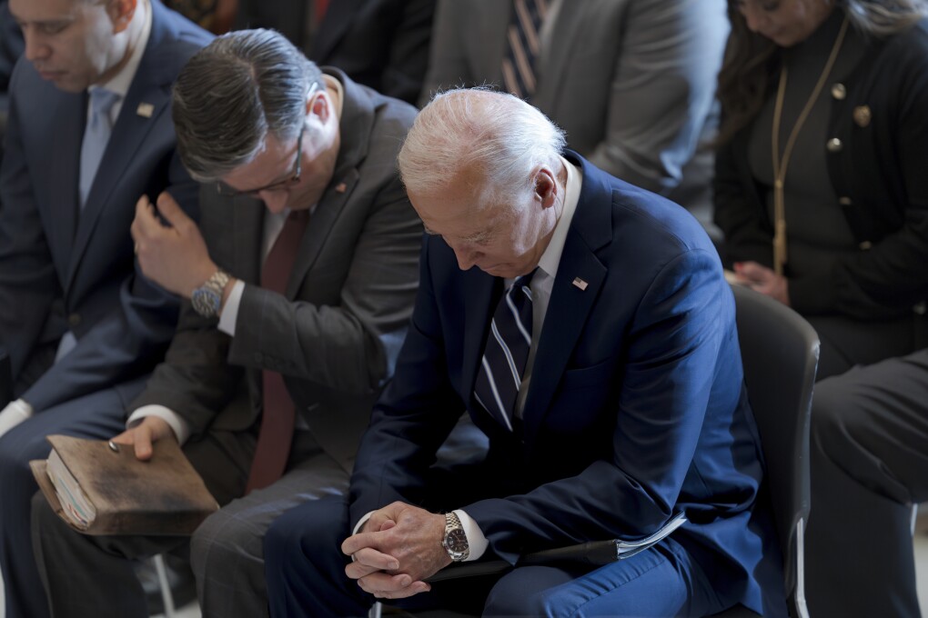 FILE- President Joe Biden, with from left, House Minority Leader Hakeem Jeffries, D-N.Y., and House Speaker Mike Johnson of La., pray and listen during the National Prayer Breakfast, Thursday, Feb. 1, 2024, at the Capitol in Washington. Johnson has spoken in the past of his belief America was founded as a Christian nation. Biden, while citing his own Catholic faith, has spoken of values shared by people of 鈥渁ny other faith, or no faith at all.鈥� (AP Photo/J. Scott Applewhite, File)