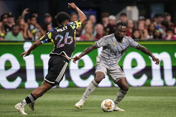 CF Montréal defender Zachary Brault-Guillard (15) moves the ball against Atlanta United defender Caleb Wiley (26) during the second half of a MLS soccer match, Saturday, Sept. 23, 2023, in Atlanta. (AP Photo/Mike Stewart)