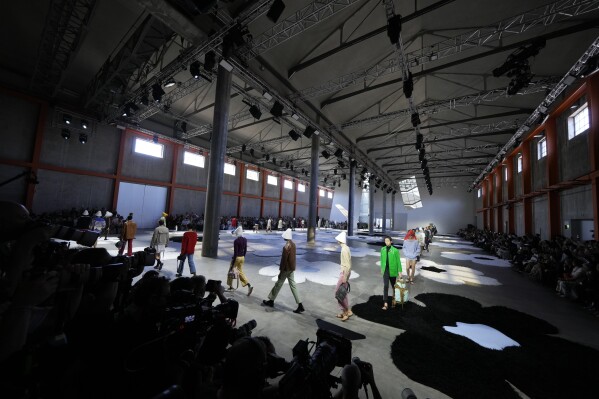 Models wear creations as part of the men's Prada Spring-Summer 2026 collection, that was presented in Milan, Italy, Sunday, June 22, 2025. (AP Photo/Luca Bruno)