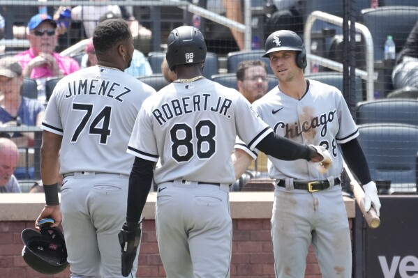 Chicago White Sox' Eloy Jimenez (74) and Luis Robert Jr. (88) celebrate with Zach Remillard after scoring on a two run double by Yasmani Grandal during the sixth inning of a baseball game against the New York Mets, Thursday, July 20, 2023, in New York. (AP Photo/Mary Altaffer)