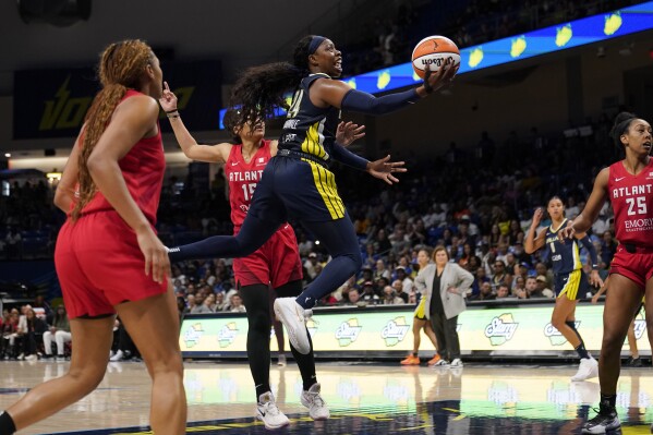 Dallas Wings guard Arike Ogunbowale shoots after getting past Atlanta Dream's Allisha Gray (15) during the second half of Game 2 of a first-round WNBA basketball playoff series Tuesday, Sept. 19, 2023, in Arlington, Texas. (AP Photo/Tony Gutierrez)