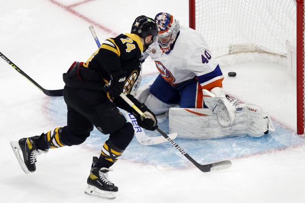 Boston Bruins' Jake DeBrusk (74) scores against New York Islanders goalie Semyon Varlamov (40) during the first period of an NHL hockey game, Saturday, Feb. 18, 2023, in Boston. (AP Photo/Michael Dwyer)
