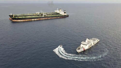 In this undated photo released Tuesday, July 11, 2023, by Indonesian Maritime Security Agency (BAKAMLA), a BAKAMLA patrol ship inspects the Iranian-flagged, MT Arman 114 and Cameroon-flagged tanker, MT S Tinos after they are caught conducting illegal oil transfer near Natuna waters, Indonesia. Indonesian authorities said Wednesday, July 12, 2023, that they have seized an Iranian tanker and arrested its crew members for illegally transferring oil to another vessel in the country’s exclusive economic zone. (BAKAMLA via AP)