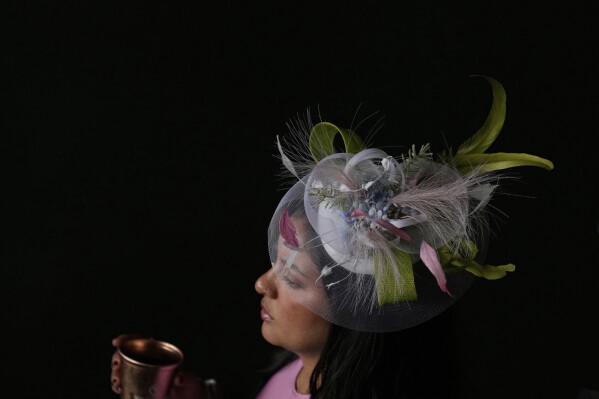 A race fan walk through a tunnel at Churchill Downs before the 151st running of the Kentucky Oaks horse race Friday, May 2, 2025, in Louisville, Ky. (AP Photo/Brynn Anderson)