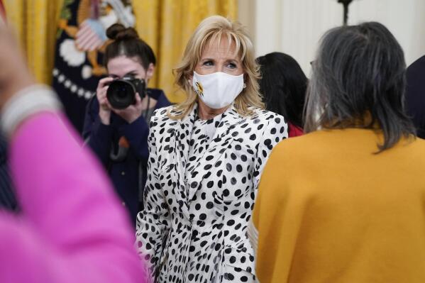First lady Jill Biden wears a mask with a sunflower, the national flower of Ukraine, in support of the Ukrainian people at an event to celebrate Black History Month in the East Room of the White House, Monday, Feb. 28, 2022, in Washington. (AP Photo/Patrick Semansky)