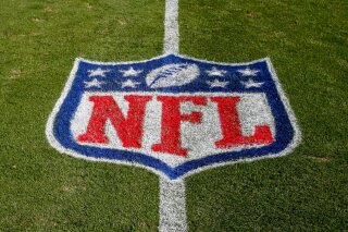 FILE - In this Nov. 4, 2018 file photo, the NFL logo is displayed on the field at the Bank of American Stadium before an NFL football game between the Tampa Bay Buccaneers and the Carolina Panthers in Charlotte, N.C. The NFL revealed Sunday, Aug. 23, 2020, that several positive COVID-19 tests were found a day earlier by one of its testing partners, and the Chicago Bears said they had nine false positives. (AP Photo/Nell Redmond, File)