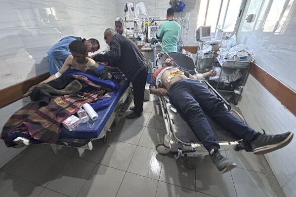 Palestinians wounded in an Israeli strike while waiting for humanitarian aid on the beach in Gaza City are treated in Shifa Hospital on Thursday, Feb. 29, 2024. (AP Photo/Mahmoud Essa)