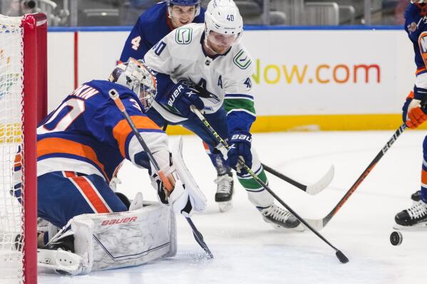 New York Islanders goaltender Ilya Sorokin (30) stops a shot by Vancouver Canucks' Elias Pettersson (40) during the first period of an NHL hockey game Thursday, Feb. 9, 2023, in Elmont, N.Y. (AP Photo/Frank Franklin II)
