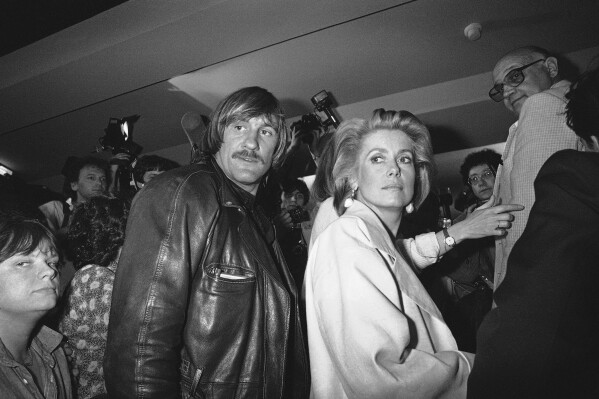 Actors Gerard Depardieu and Catherine Deneuve are seen in Cannes, southern France, on May 11 1984. (AP Photo/Michel Lipchitz, File)