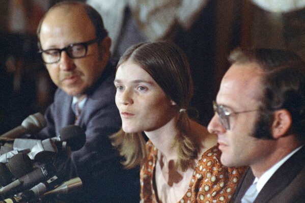 FILE - In this Aug. 19, 1970, file photo, Linda Kasabian speaks at a news conference she held at end of her 18 days on stand as a prosecution witness in the Manson Family murder trials in Los Angeles. Attorneys are Roland Goldman at her left, and Gary Fleischman at her right. Kasabian, the trial's key prosecution witness, was granted immunity from prosecution. She drove the killers to the Tate and LaBianca houses but didn't take part in the killings. Kasabian later changed her name and has for the most part lived out of sight for the past 50 years. (AP Photo/David F. Smith, File)