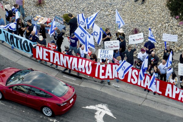Protesters rally outside Tesla's Fremont, Calif., factory as Israeli Prime Minister Benjamin Netanyahu plans a visit with businessman Elon Musk on Monday, Sept. 18, 2023. (AP Photo/Noah Berger)