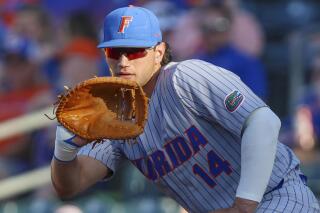 FILE - Florida's Jac Caglianone (14) waits for a throw to first during an NCAA baseball game against Florida State on Tuesday, May 2, 2023, in Jacksonville, Fla. Caglianone, the front-runner for John Olerud Two-Way Player of the Year, is listed as the No. 11 prospect for the 2024 amateur draft. (AP Photo/Gary McCullough, File)