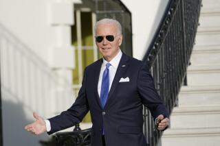 President Joe Biden gestures to reporters as he returns to the White House in Washington, Thursday, Dec. 2, 2021. Biden had visited to the National Institutes of Health. (AP Photo/Susan Walsh)
