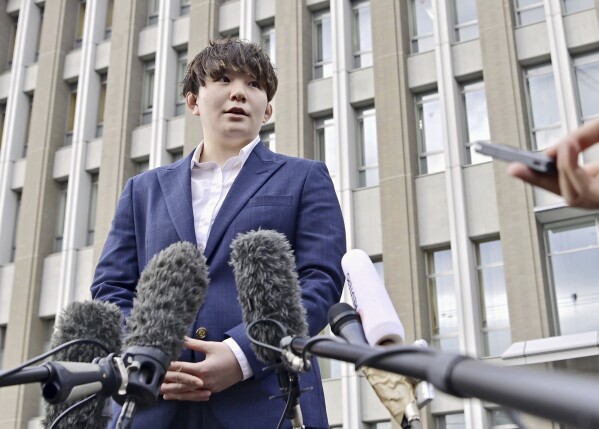 Rina Gonoi, former member of the Japan Ground Self-Defense Forces, speaks to the media after a ruling at the Fukushima District Court in Fukushima, northeastern Japan, Tuesday, Dec. 12, 2023. A Japanese court on Tuesday convicted three former soldiers in a sexual assault case that authorities had dropped until the victim, a former service member, came forward demanding a reinvestigation, prompting a military-wide harassment probe.(Kyodo News via AP)