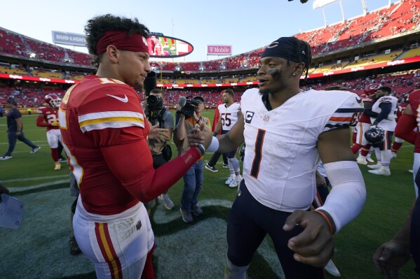 Kansas City Chiefs quarterback Patrick Mahomes, left, and Chicago Bears quarterback Justin Fields (1) shake hands following an NFL football game Sunday, Sept. 24, 2023, in Kansas City, Mo. The Chiefs won 41-10. (AP Photo/Charlie Riedel)