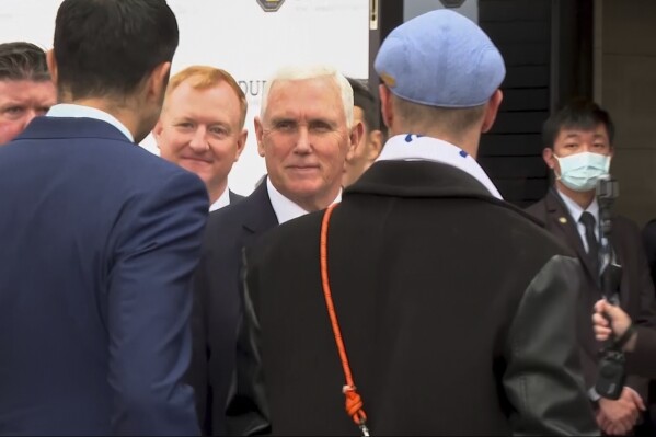 In this image made from video, former U.S. Vice President Mike Pence, center, arrives to attend an educational forum in Taipei, Taiwan, Friday, Jan. 17, 2025. (AP Photo/Johnson Lai)