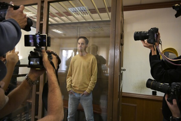 FILE - Wall Street Journal reporter Evan Gershkovich stands in a glass cage in a courtroom in Moscow, Russia, on Tuesday, Sept. 19, 2023. Arrests of Americans in Russia have become increasingly common as relations between Moscow and Washington sink to Cold War lows. Some have been exchanged for Russians held in the U.S., while for others, the prospects of being released in a swap are less clear. (AP Photo/Dmitry Serebryakov, File)