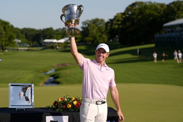 Rory McIlroy, of Northern Ireland, holds the trophy after winning the Wells Fargo Championship golf tournament at the Quail Hollow Club Sunday, May 12, 2024, in Charlotte, N.C. (AP Photo/Chris Carlson)