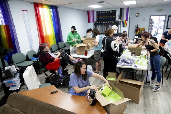 People help assemble reproductive health kits at a reproductive health kit packing party held at The Community Center in Boise, Idaho, on Friday, April 12, 2024. About two dozen people filled boxes with emergency contraception, condoms and information about accessing abortions. (AP Photo/Kyle Green)