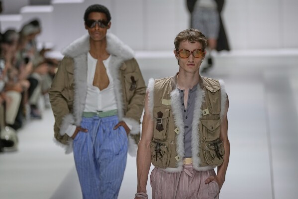 Models wear creations as part of the men's Dolce & Gabbana Spring-Summer 2026 collection, that was presented in Milan, Italy, Saturday, June 21, 2025. (AP Photo/Luca Bruno).