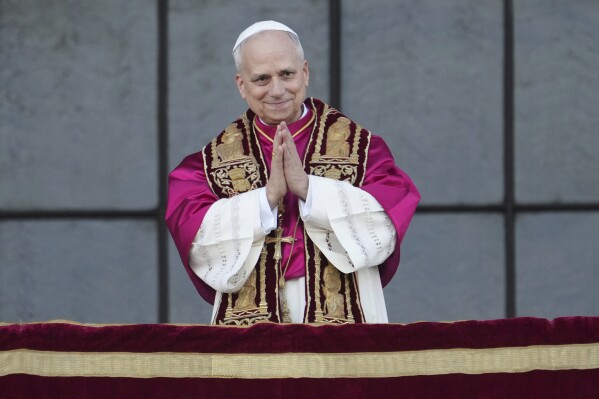 Pope Leo XIV appears at the central balcony of the Arch Basilica of St. John Lateran after presiding over a Mass and takes possession of the Roman Cathedra, formalising his role as Bishop of Rome, in Rome, Sunday, May 25, 2025. (AP Photo/Andrew Medichini)