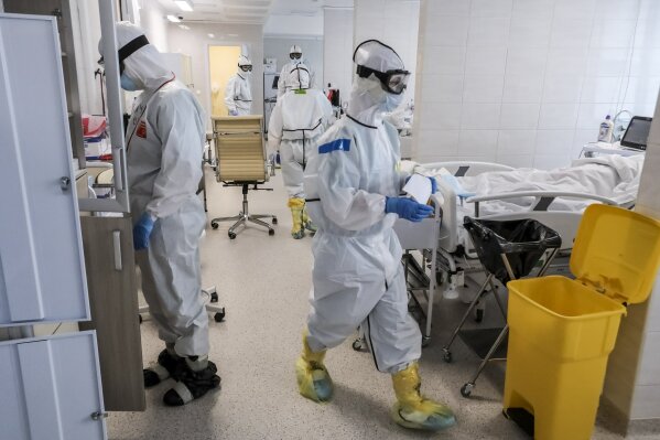 In this photo taken on Saturday, May 2, 2020, doctors work inside the intensive care unit for people infected with the new coronavirus, at a hospital in Moscow, Russia. A Russian epidemiologist says the sharp increase in coronavirus infection cases recorded over the past week reflects increased testing. Russia on Sunday reported more then ten thousand new cases, nearly double the new cases reported a week ago and the first time the daily tally went into five digits.(AP Photo/Sophia Sandurskaya)