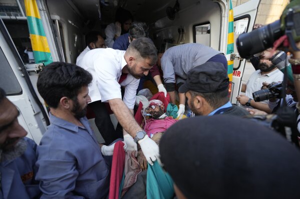 A man injured after a passenger bus slid off a Himalayan highway is brought for treatment at a government hospital in Jammu, India, Wednesday, Nov.15, 2023. Nearly three dozen people were killed and more than a dozen were injured in the accident. (AP Photo/Channi Anand)